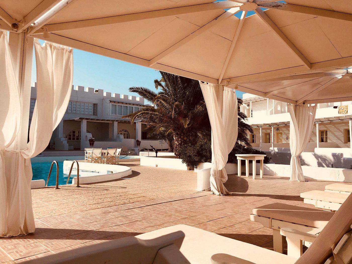 Poolside cabanas and loungers at golden hour