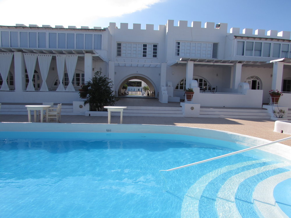 Pool and hotel building in the sunshine