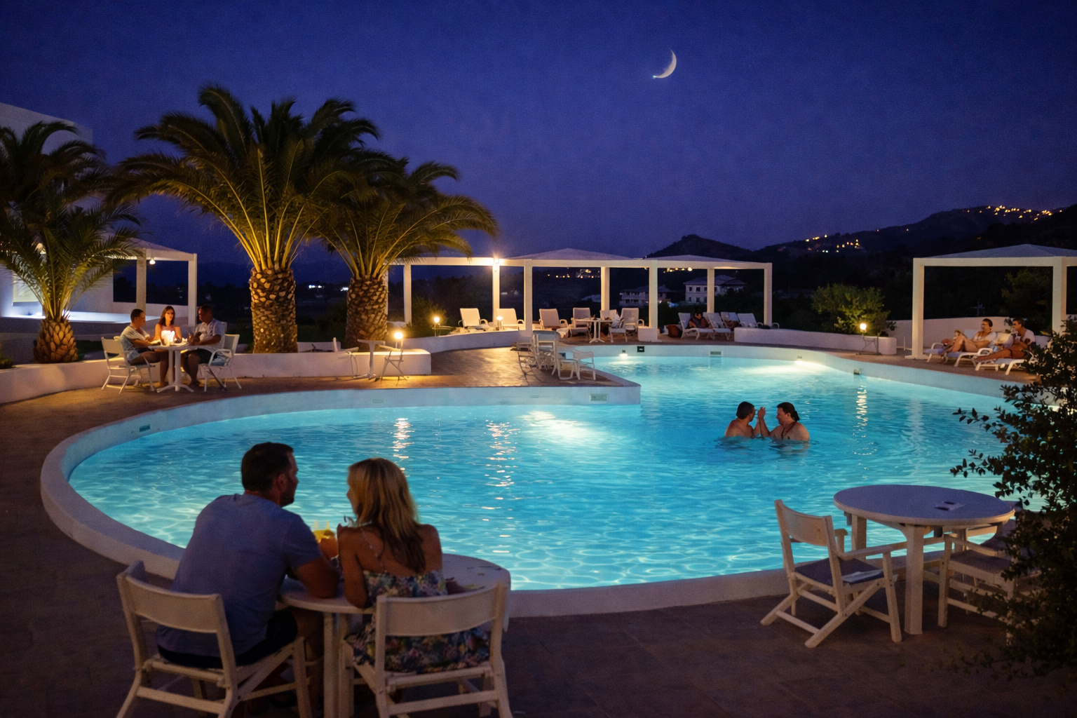 Evening poolside under a crescent moon